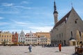 Travelers walking by cathedral exploring city square in old town against sky Royalty Free Stock Photo