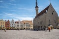 Travelers walking by church while exploring city square in old town against sky Royalty Free Stock Photo