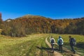 Travelers walking on an contry road autumn colours