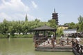 Travelers walking cross the wooden bridge besides Haogu Tower (Jiaxing,China) Royalty Free Stock Photo