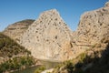 Travelers walking on a suspension road along a sheer cliff. Caminito del Rey. Dangerous trail in mountains.