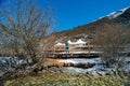 Travelers walking on walkway with snow-capped mountains to Milk Lake in Yading Nature Reserve, Sichuan, China