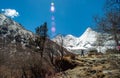 Travelers walking on walkway with snow-capped mountains to Milk Lake in Yading Nature Reserve, Sichuan, China