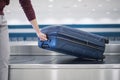 Suitcase on baggage claim in airport terminal Royalty Free Stock Photo