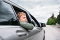 Traveling by auto - son and father look out from car windows