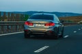 Traveling BMW car in motion on asphalt road, back view of car on street. Bucharest, Romania, 2020 Royalty Free Stock Photo