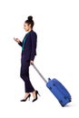 Traveling businesswoman walking with bag and mobile phone