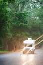 Traveling in a campervan on the pine road at dusk Royalty Free Stock Photo