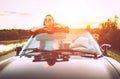 Traveling by car - couple in love go by cabriolet car in sunset Royalty Free Stock Photo