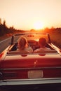 Traveling by car - happy couple in love go by cabriolet car in sunset time AI generated Royalty Free Stock Photo