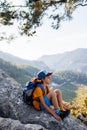 Traveling child. tourist with a backpack is resting on a mountain path. hiking and active healthy lifestyle