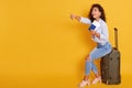 Traveling Concept. Portrait of cheerful exited young caucasian woman, dressed casual clothing, holding passport with flying Royalty Free Stock Photo