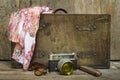 Traveling concept of retro consists suitcase, camera, sunglasses, mouth organ and shawl on wooden background