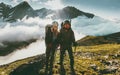 Traveling Couple climbing together in mountains