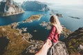 Traveling Couple follow holding hands on cliff mountain