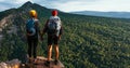 A traveling couple in the mountains. A man and a woman on the background of a mountain, a panorama. Climbing the mountain. Hiking