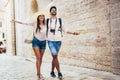 Traveling couple of tourists walking around old town.