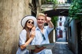 Traveling couple tourists walking around old town. Vacation, summer, holiday, tourism concept Royalty Free Stock Photo