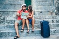 Traveling couple of tourists walking around old town. Royalty Free Stock Photo