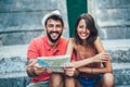 Traveling couple of tourists walking around old town. Royalty Free Stock Photo