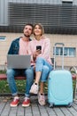 Traveling. Couple Using Laptop, Waiting Transport Near Airport Royalty Free Stock Photo