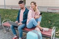 Traveling. Couple using laptop, waiting transport near airport Royalty Free Stock Photo