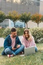 Traveling. Couple using laptop, waiting transport near airport Royalty Free Stock Photo