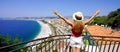 Traveling in France. Panoramic view of beautiful girl with open arms on Nice city, French Riviera Royalty Free Stock Photo