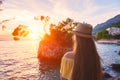 Traveling girl enjoys amazing sunset view and Brela stone and Adriatic seacoast. Travel background, Croatia Royalty Free Stock Photo