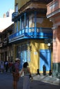 Obispo Street. Yellow house with blue balconies and shutters