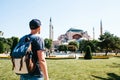 A traveling man with a backpack in Sultanahmet Square near the famous Aya Sofia mosque in Istanbul in Turkey. Travel Royalty Free Stock Photo