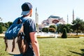 A traveling man with a backpack in Sultanahmet Square near the famous Aya Sofia mosque in Istanbul in Turkey. Travel Royalty Free Stock Photo