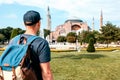 A traveling man with a backpack in Sultanahmet Square near the famous Aya Sofia mosque in Istanbul in Turkey. Travel Royalty Free Stock Photo