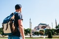 A traveling man with a backpack in Sultanahmet Square near the famous Aya Sofia mosque in Istanbul in Turkey. Travel Royalty Free Stock Photo