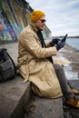 Traveling Man With Mobile Phone And Hat, In winter City, Urban Space. Royalty Free Stock Photo