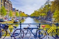 Traveling In the Netherlands. City of Amsterdam. Traditional Dutch Bicycles In Front of Amsterdam Canal