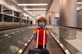 Traveling during a pandemic. A boy with a suitcase at the airport. Closed flights.