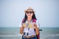 Traveling people concept. Young happy asian gril at the beach