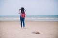 Traveling people concept. Young happy asian gril at the beach