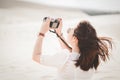 Traveling and photography. Young woman with camera taking photo.