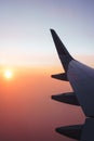 Traveling by plane. View from the window to the clouds and dawn.