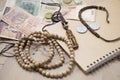 Traveling retro still life closeup with map, money, coins, buddhist mala bracelet, diary. Royalty Free Stock Photo