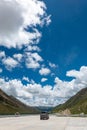 Visitors on 318 highway in Tibet under Blue sky white cloud Royalty Free Stock Photo