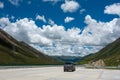 Visitors on 318 highway in Tibet under Blue sky white cloud Royalty Free Stock Photo