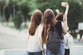 Friends taking selfie together at city background