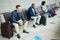 Traveling, tablet and man in airport, passport and luggage with tourist waiting, boarding or international. Male leader Royalty Free Stock Photo