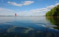 Traveling under sail.Sailboat sail off into the sunset on Lake. Royalty Free Stock Photo