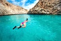 Traveling and watersports details - wide angle view of woman swimming and snorkeling