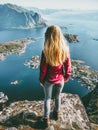 Traveling Woman on Reinebringen mointain over fjord