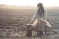 Traveling woman sits down to rest after a long trip